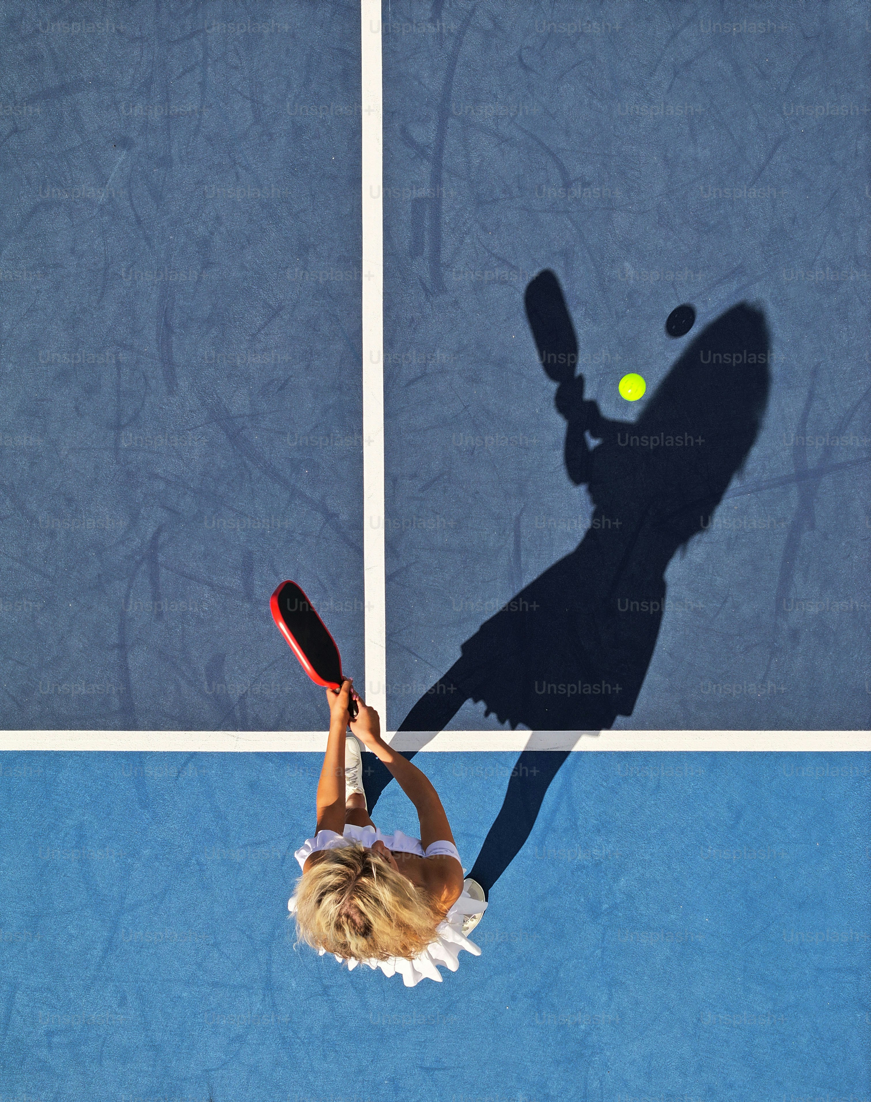 a woman holding a tennis racquet on top of a tennis court