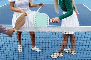 a couple of women standing on top of a tennis court holding racquets