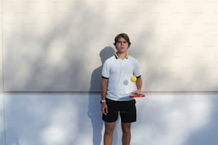 a man holding a tennis racket and a tennis ball