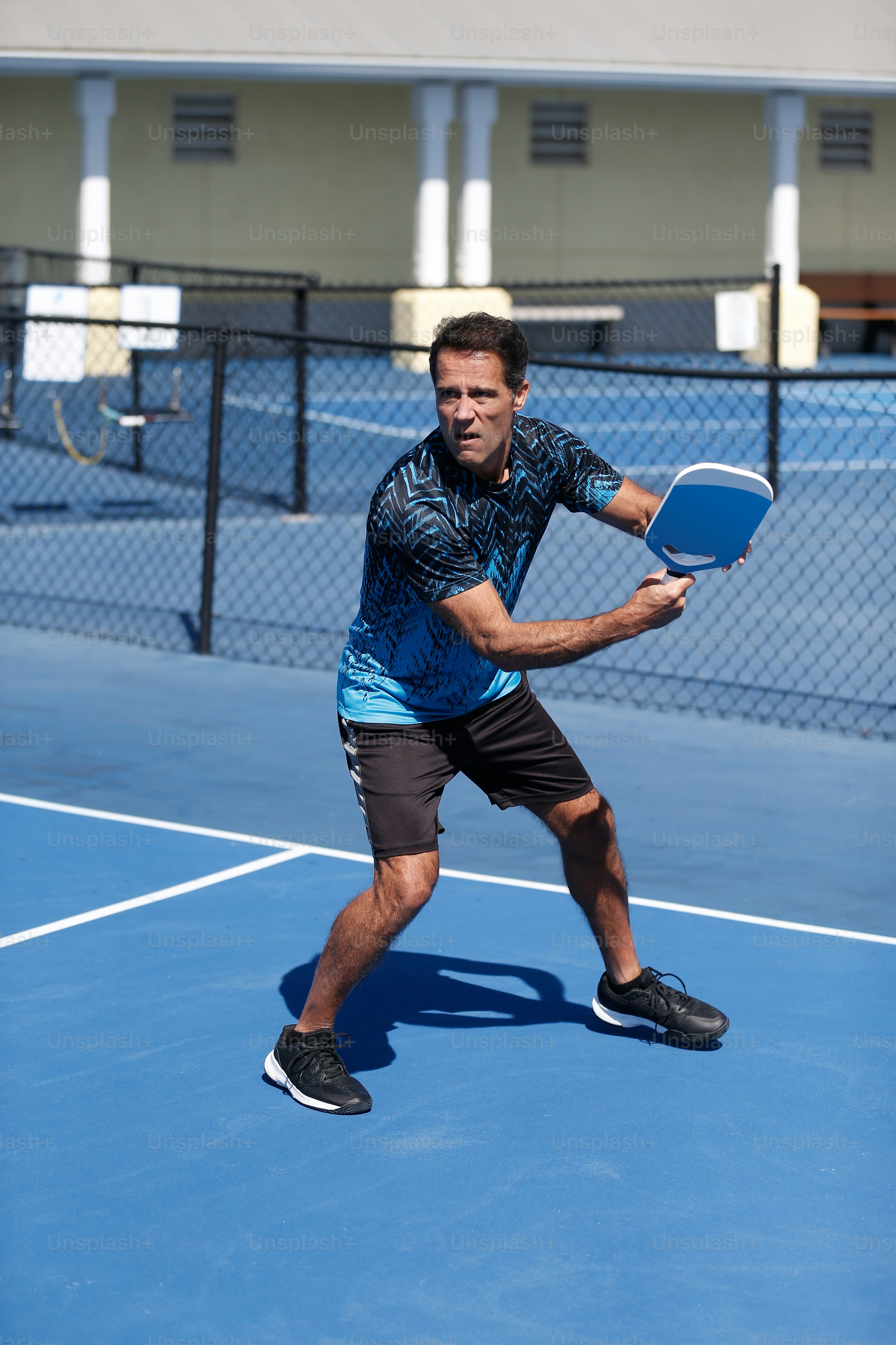 a man holding a tennis racquet on a tennis court