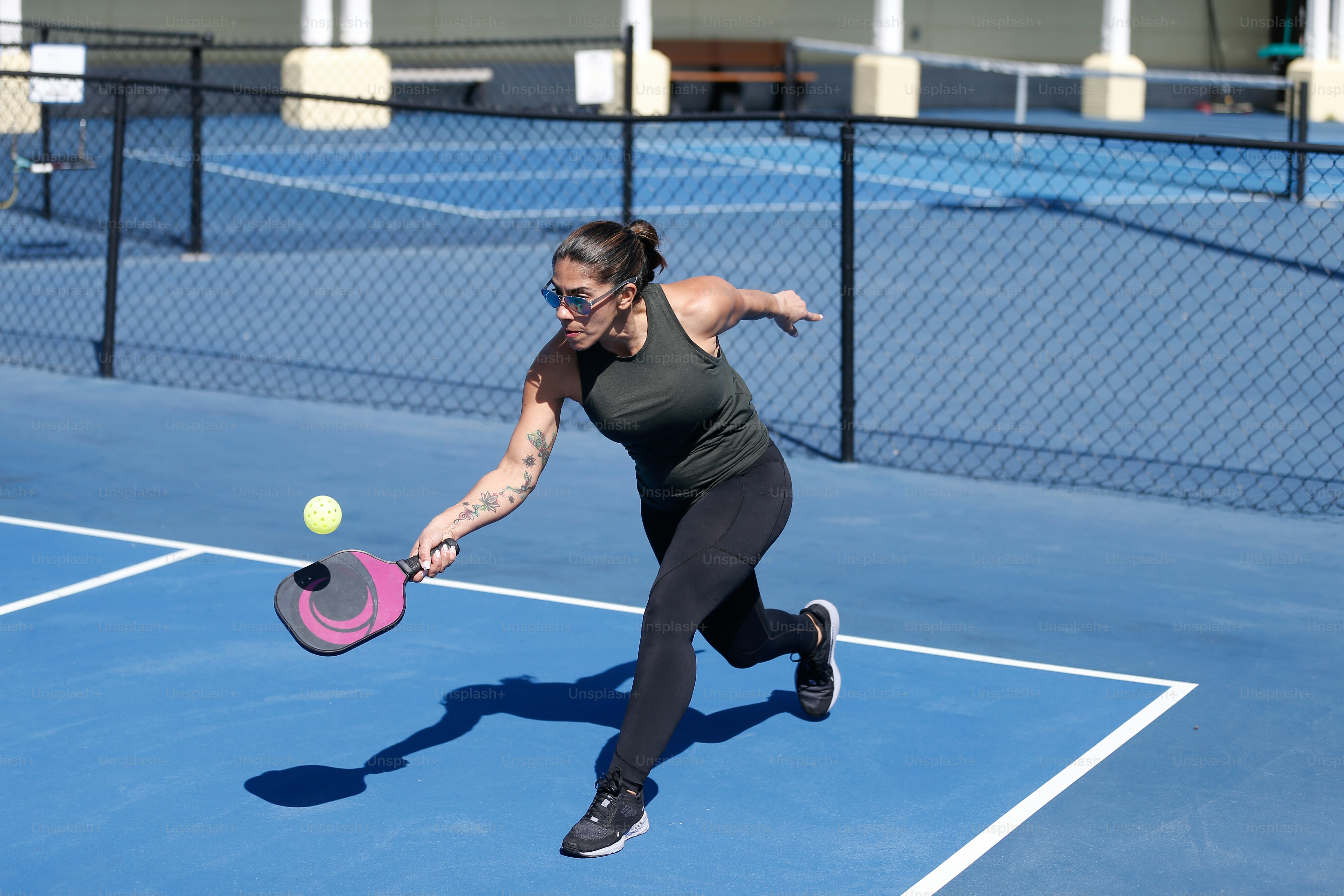 a woman hitting a tennis ball with a racquet