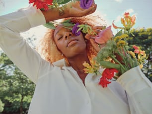 a woman is holding flowers in her hands