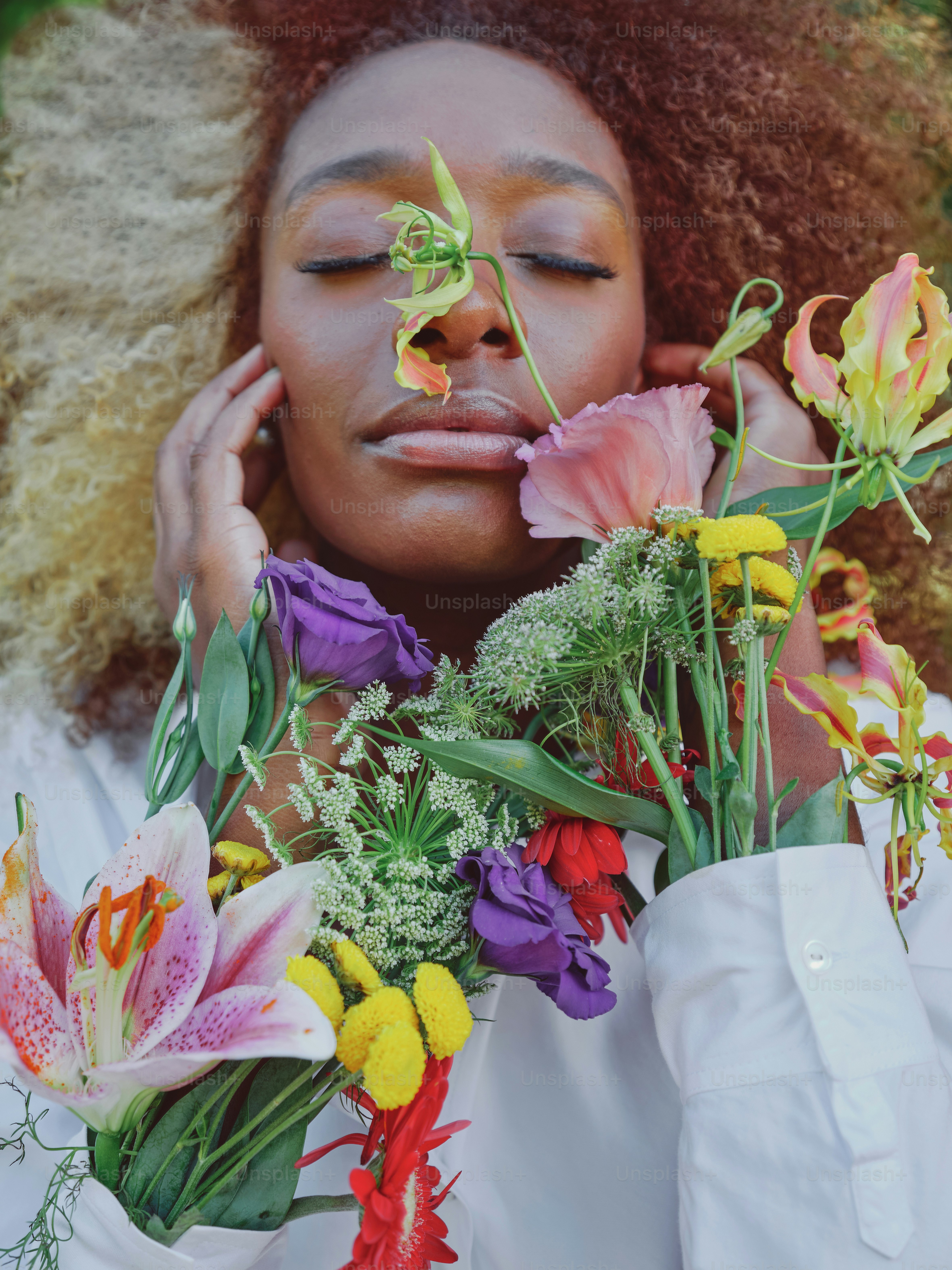 A woman holding flowers in front of her face photo – Flower bouquet ...
