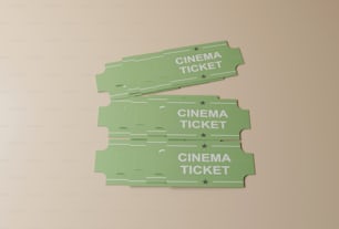 two green cinema tickets sitting on top of a table