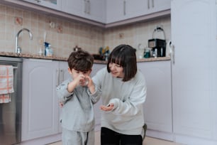a woman and a child standing in a kitchen