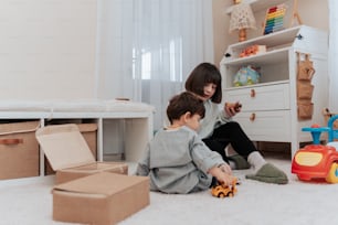 two children playing with toys in a room