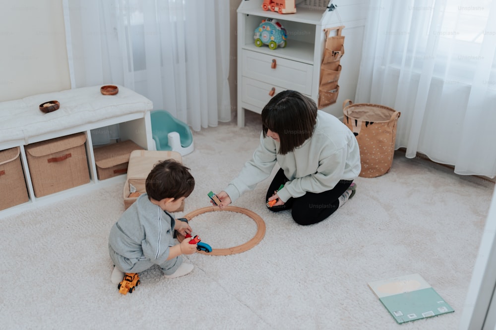 a woman and a child are playing with a toy