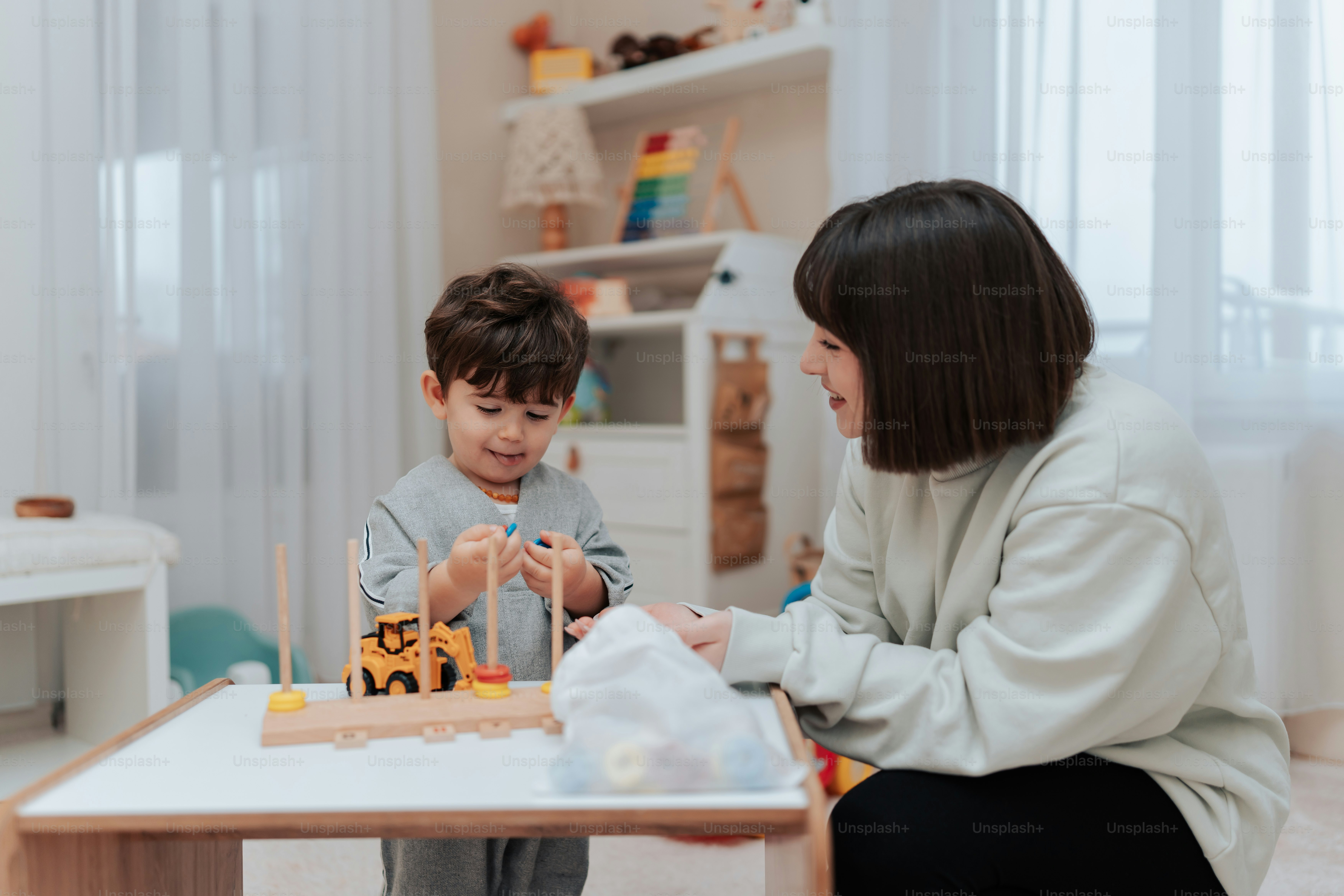 a woman sitting next to a child in a room