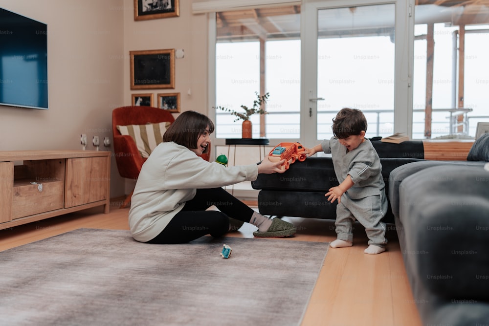 a woman playing with a child in a living room