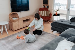 a woman playing with a child in a living room