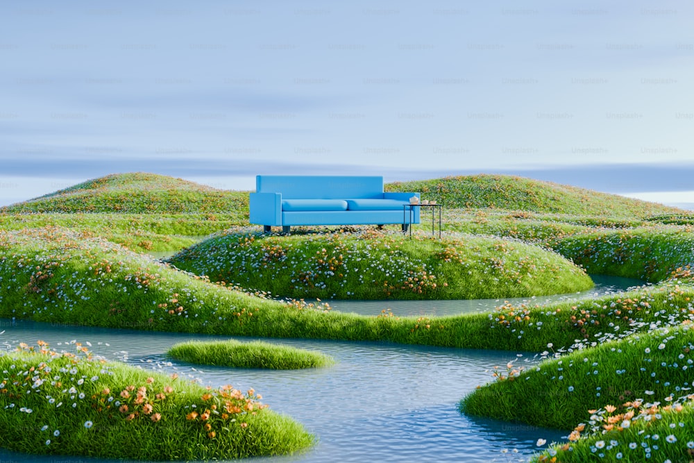 a blue couch sitting on top of a lush green field