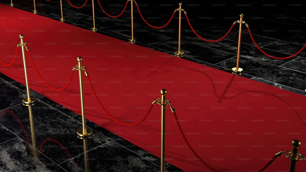 um tapete vermelho com barreiras de ouro e cordas