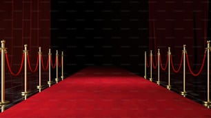 a red carpet with gold poles and a red carpet