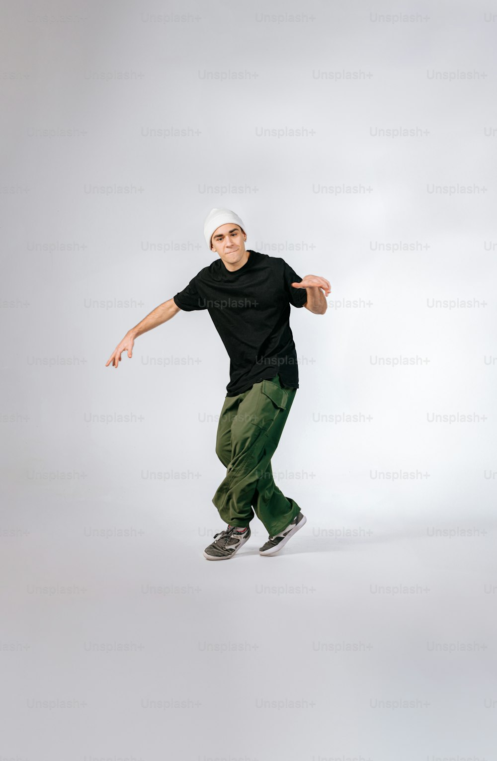 a man in black shirt and green pants doing a trick