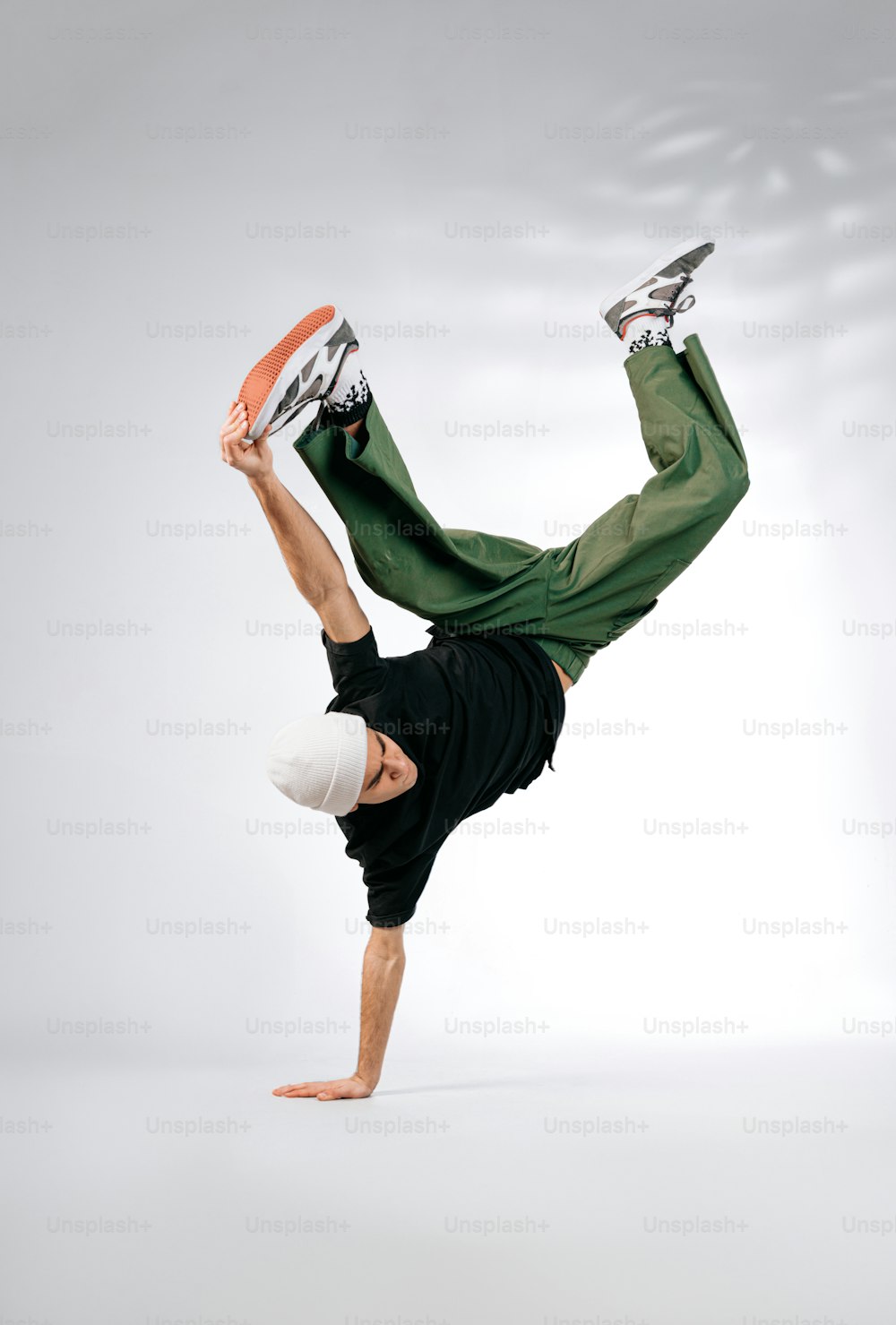 a man doing a handstand with a frisbee