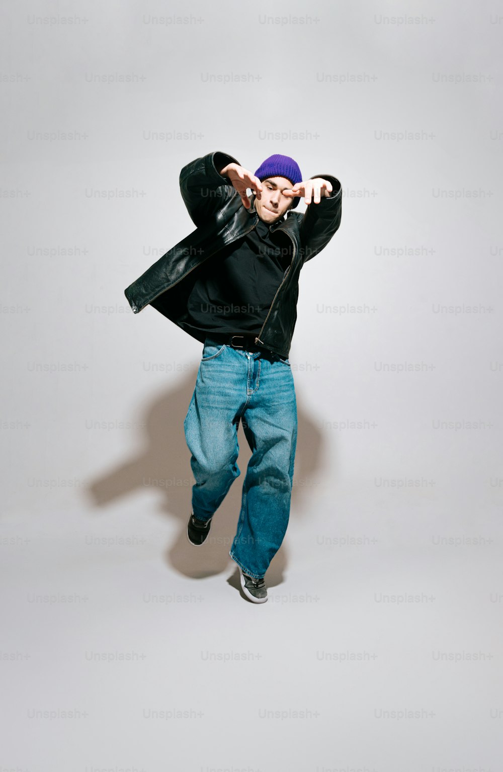 a person jumping in the air with a hat on