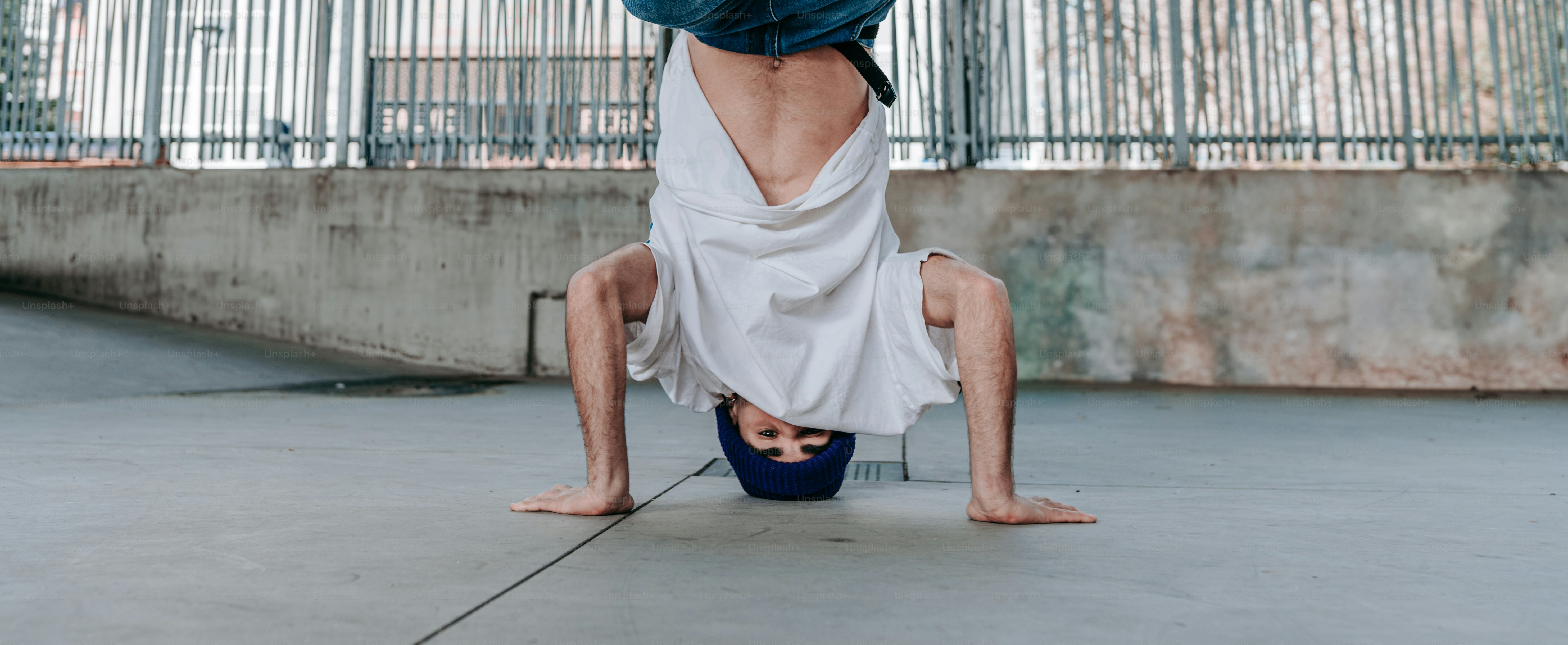 a man doing a handstand on a skateboard