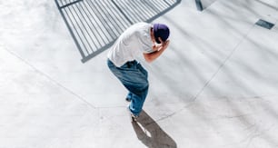 a man standing on a sidewalk talking on a cell phone