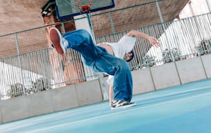 a man is doing a trick on a basketball court