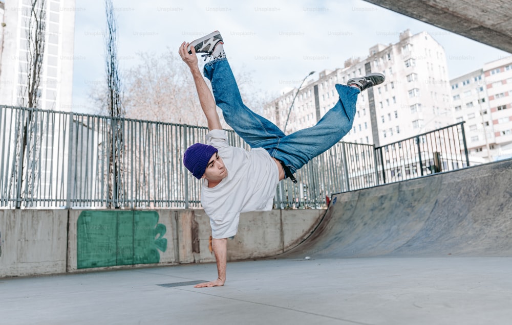 a man doing a handstand on a skateboard