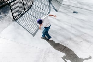 a young man riding a skateboard down a ramp