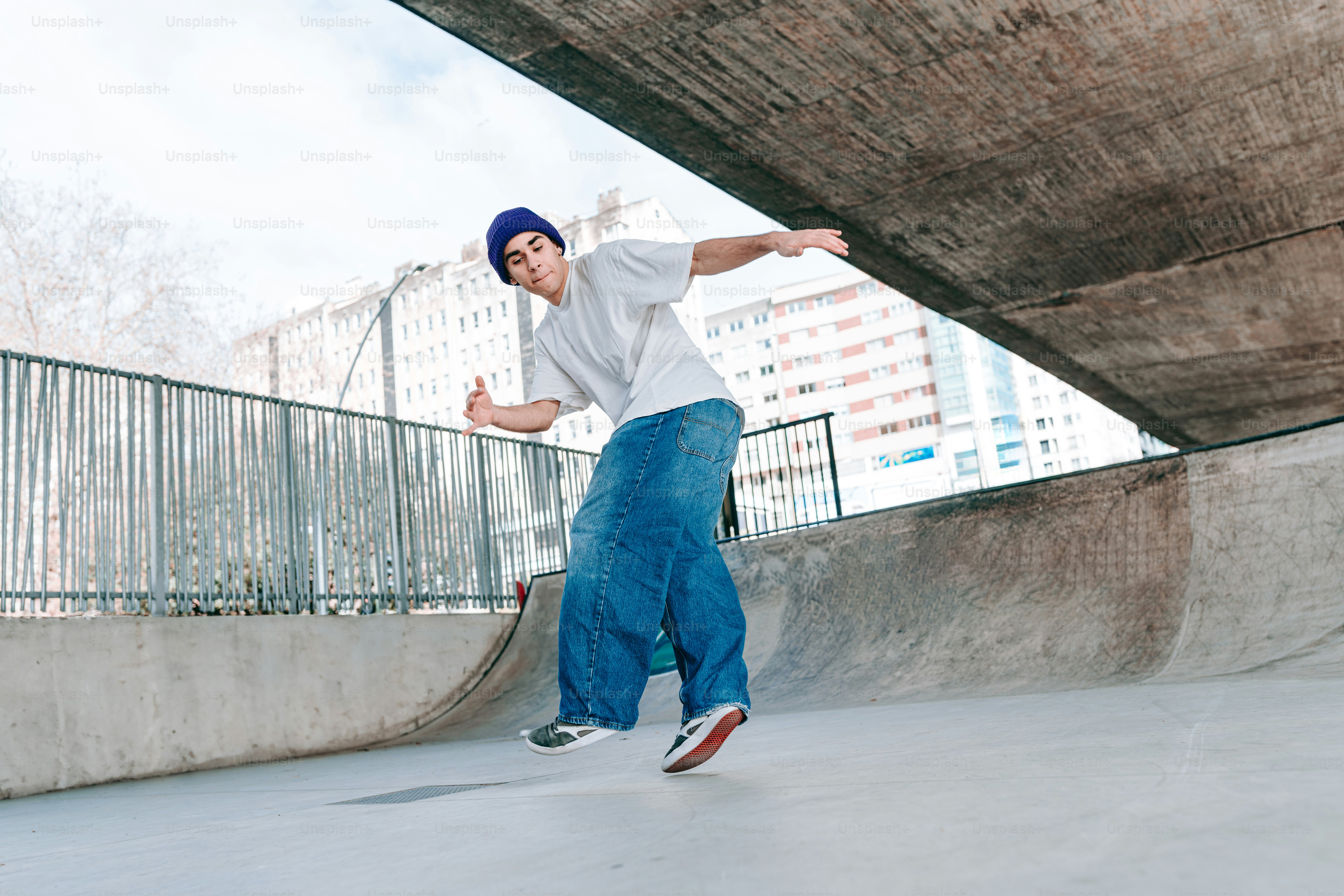 a man riding a skateboard under a bridge