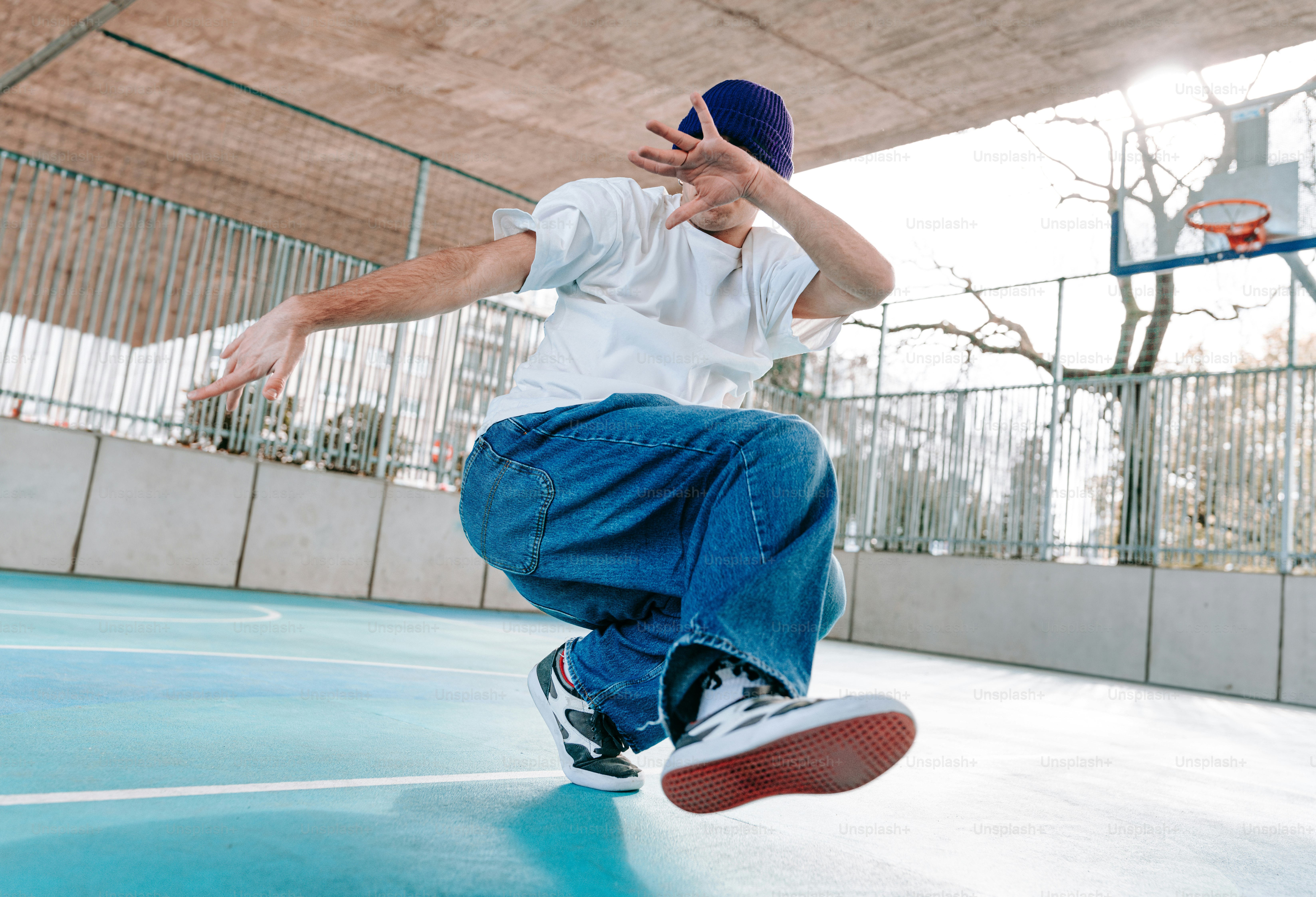 a man is doing a trick on a basketball court