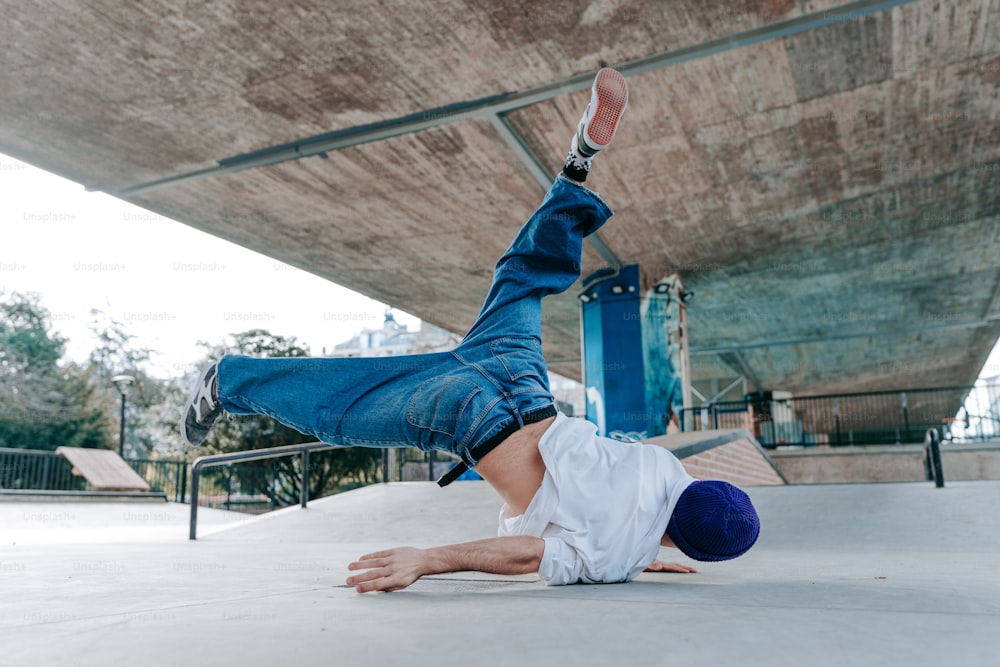 a man is doing a handstand on a skateboard