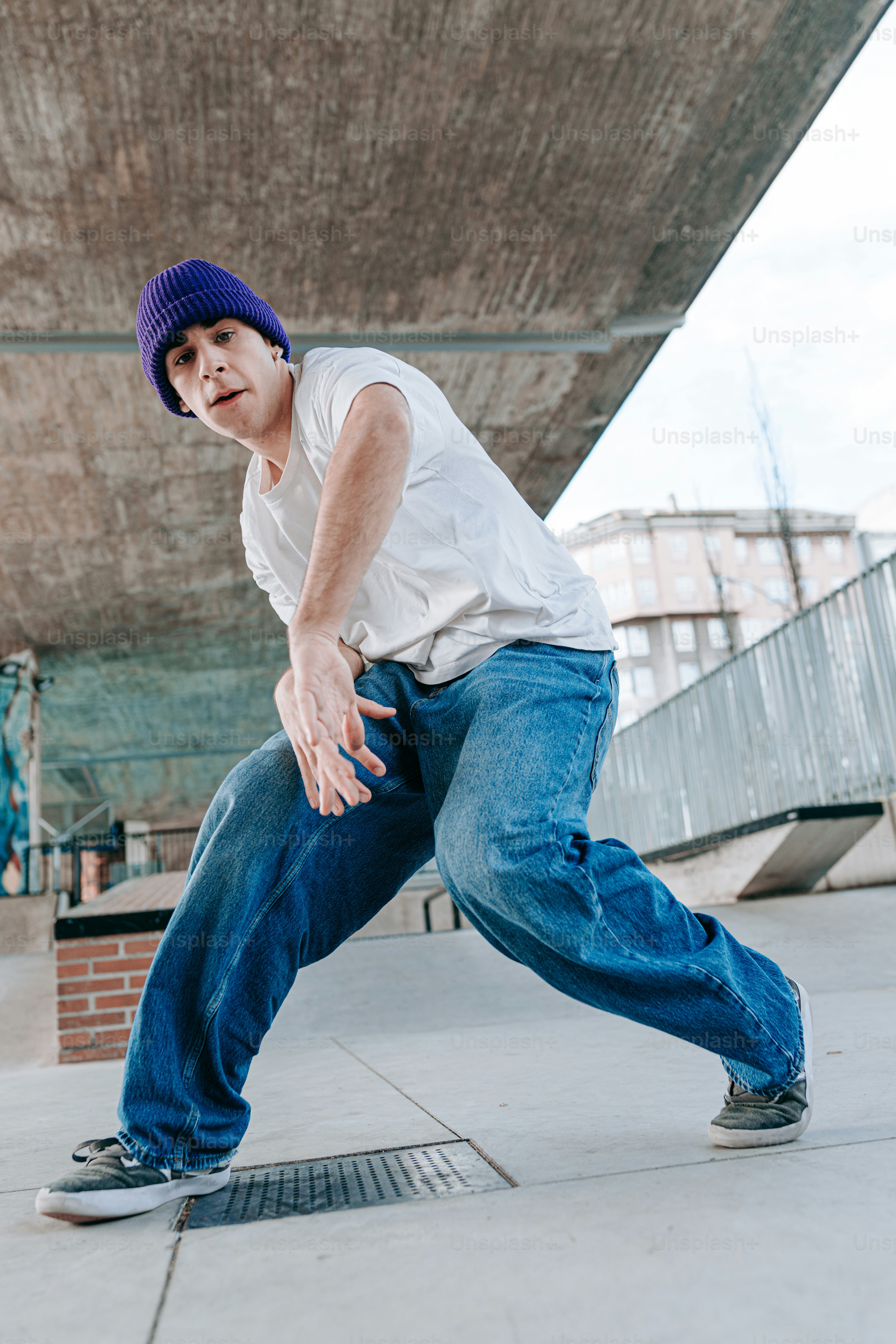 a young man riding a skateboard down a sidewalk