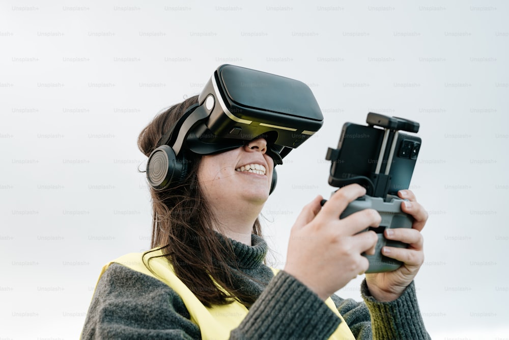 a woman wearing a yellow vest holding a camera and wearing a pair of headphones