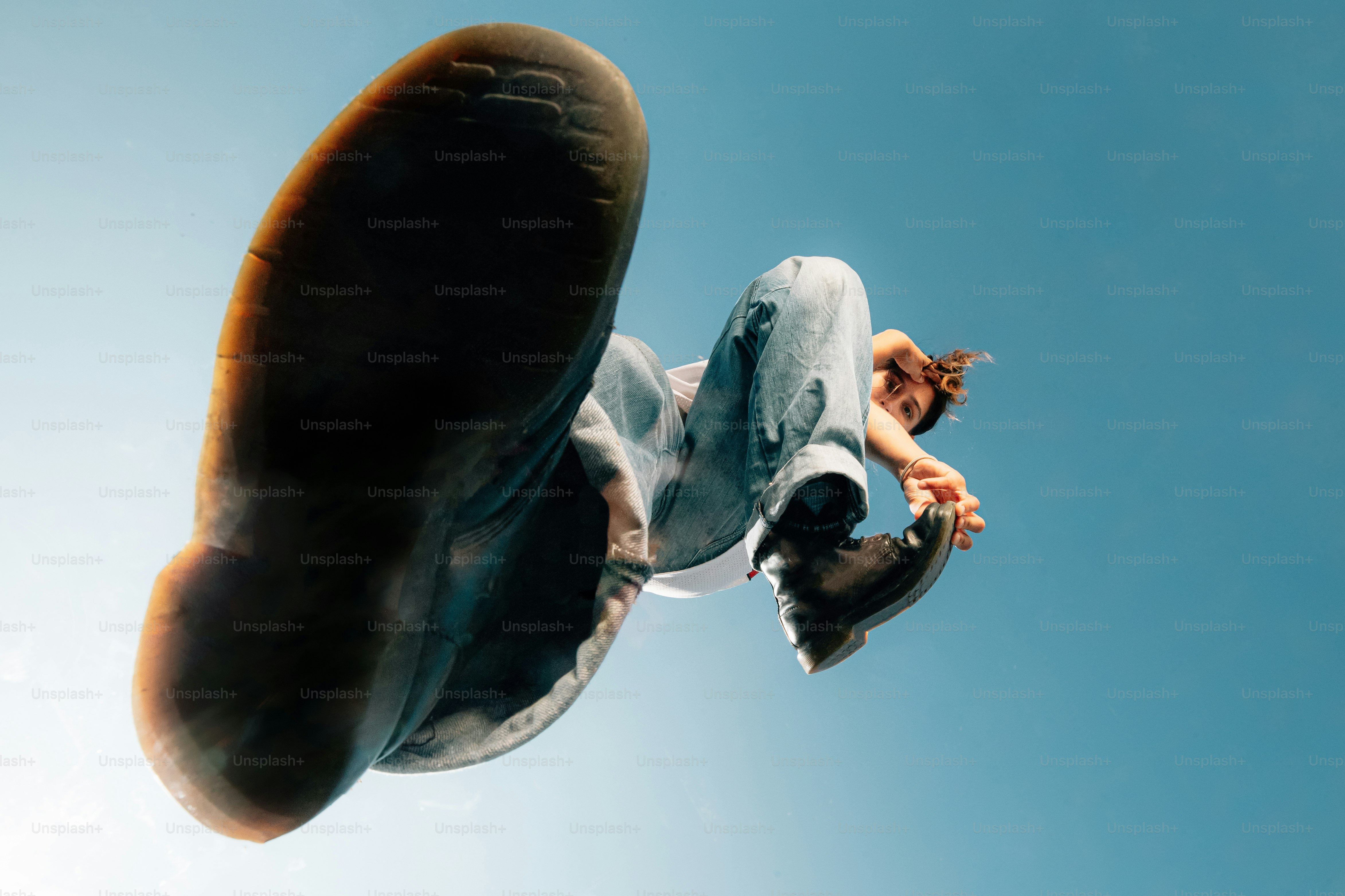 a man flying through the air while riding a skateboard
