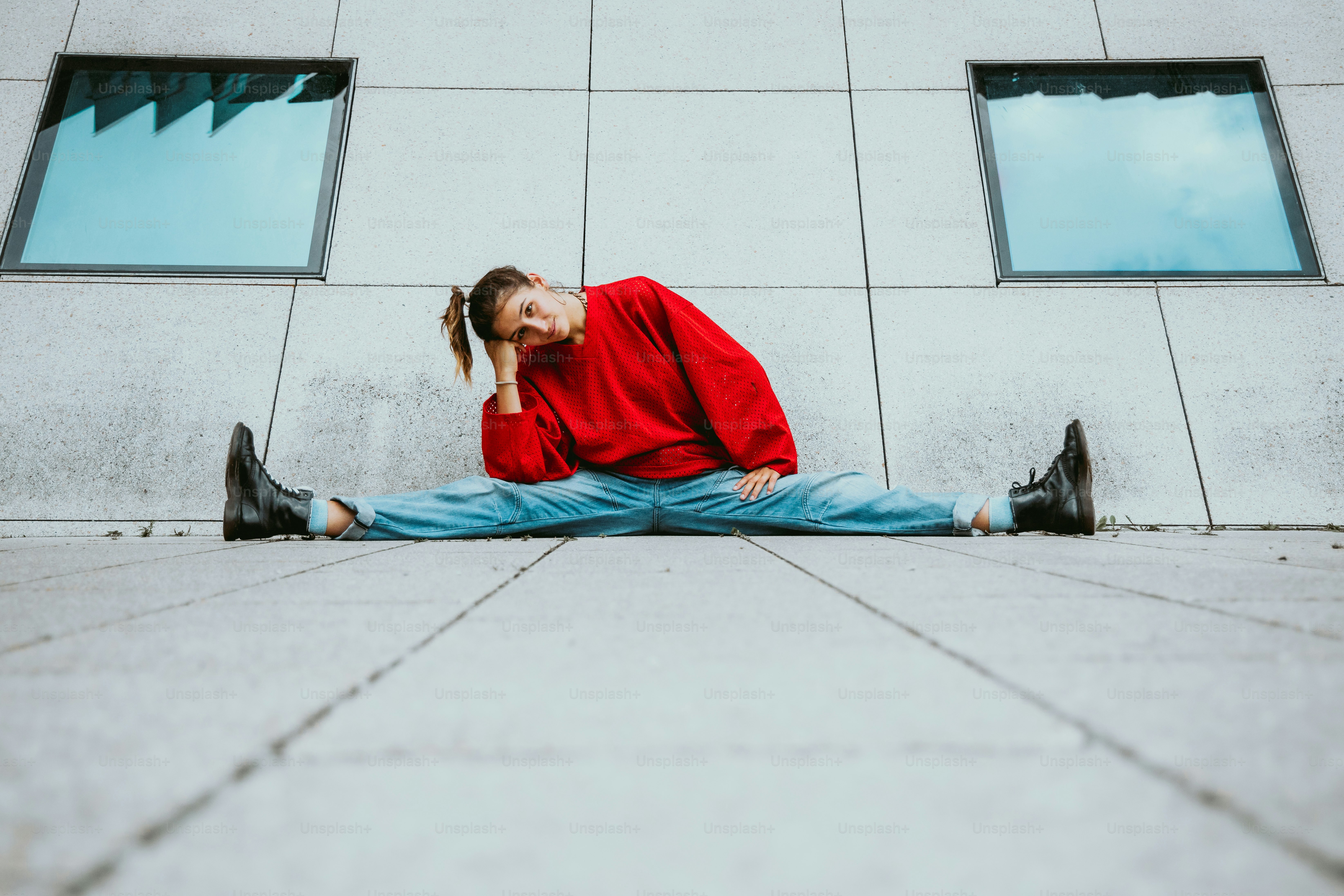 a man sitting on the ground with his head in his hands