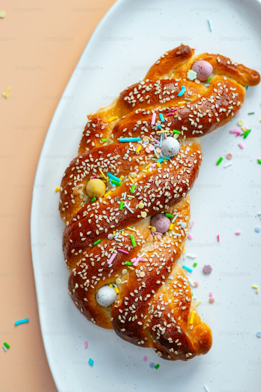 a white plate topped with a pastry covered in sprinkles