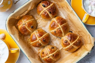 a baking pan filled with hot cross buns