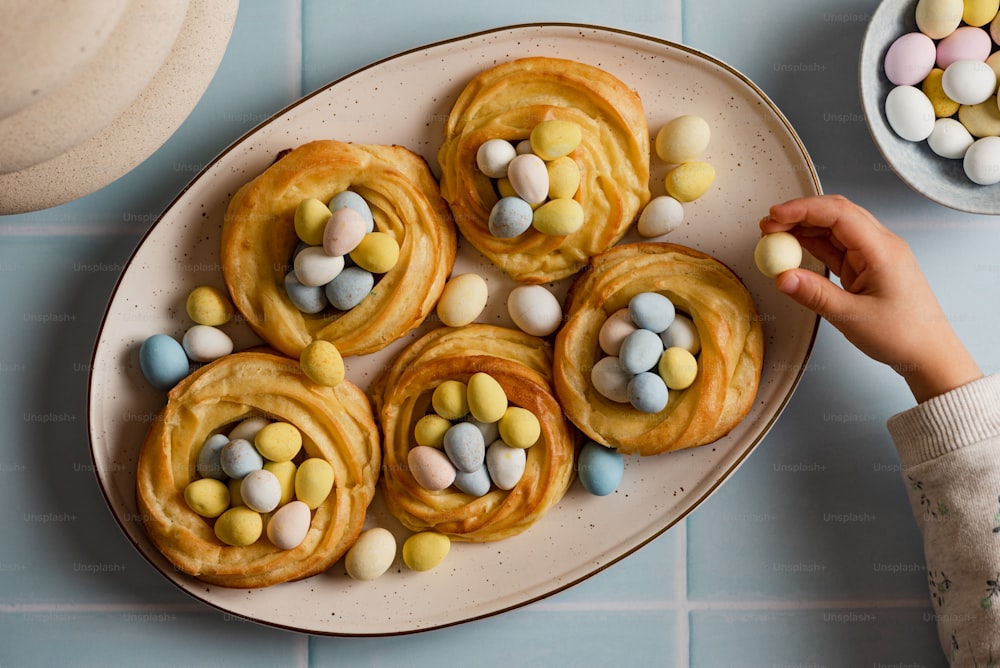 a plate of cookies with candy eggs on it