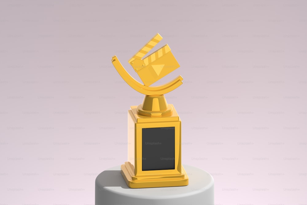 a golden trophy sitting on top of a white pedestal