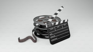 a film reel and a clapstick on a white background