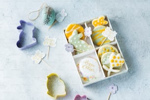 a box of decorated cookies sitting on top of a table