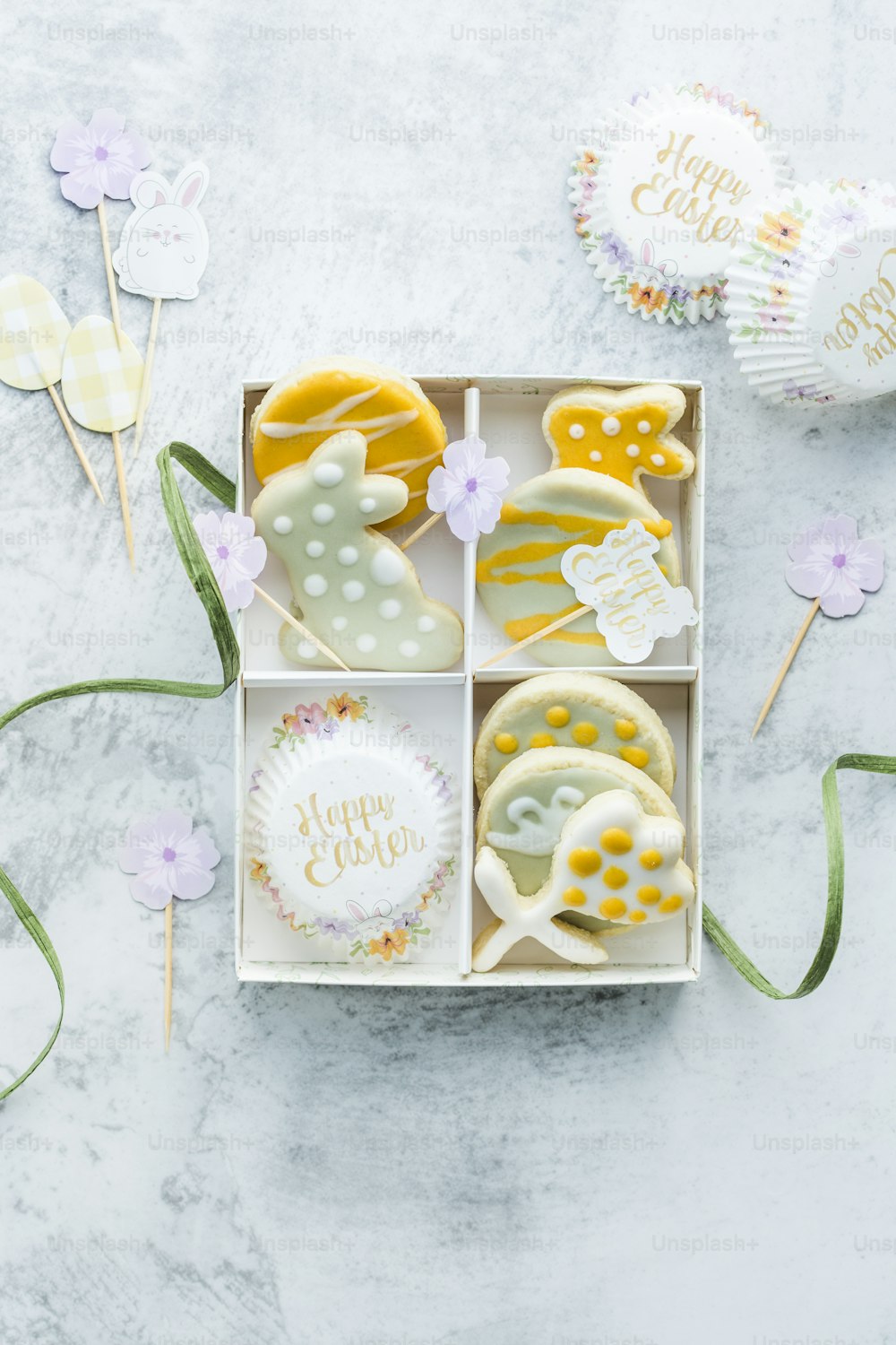 a box of decorated cookies on a table