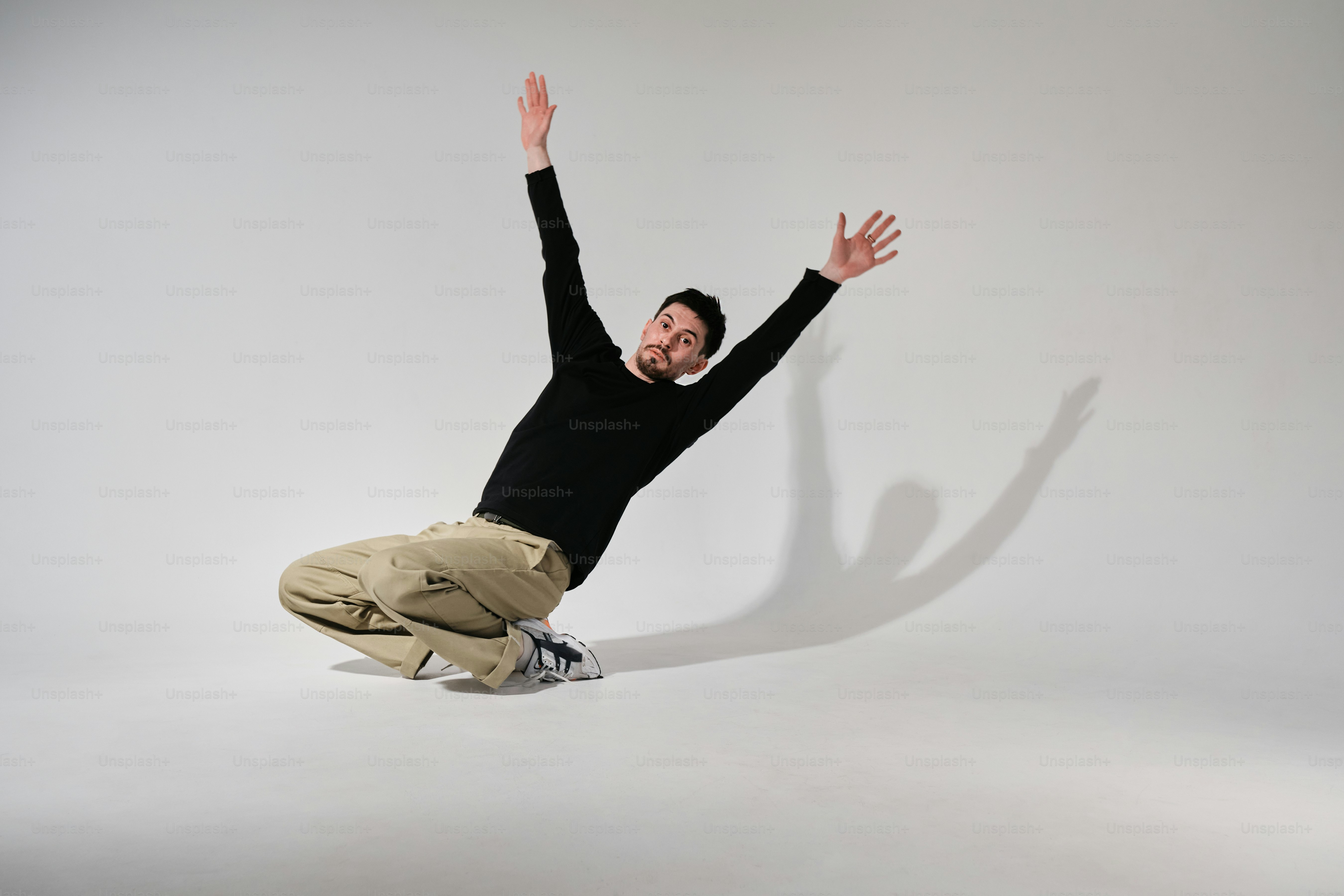 a man in black shirt doing a trick on a skateboard