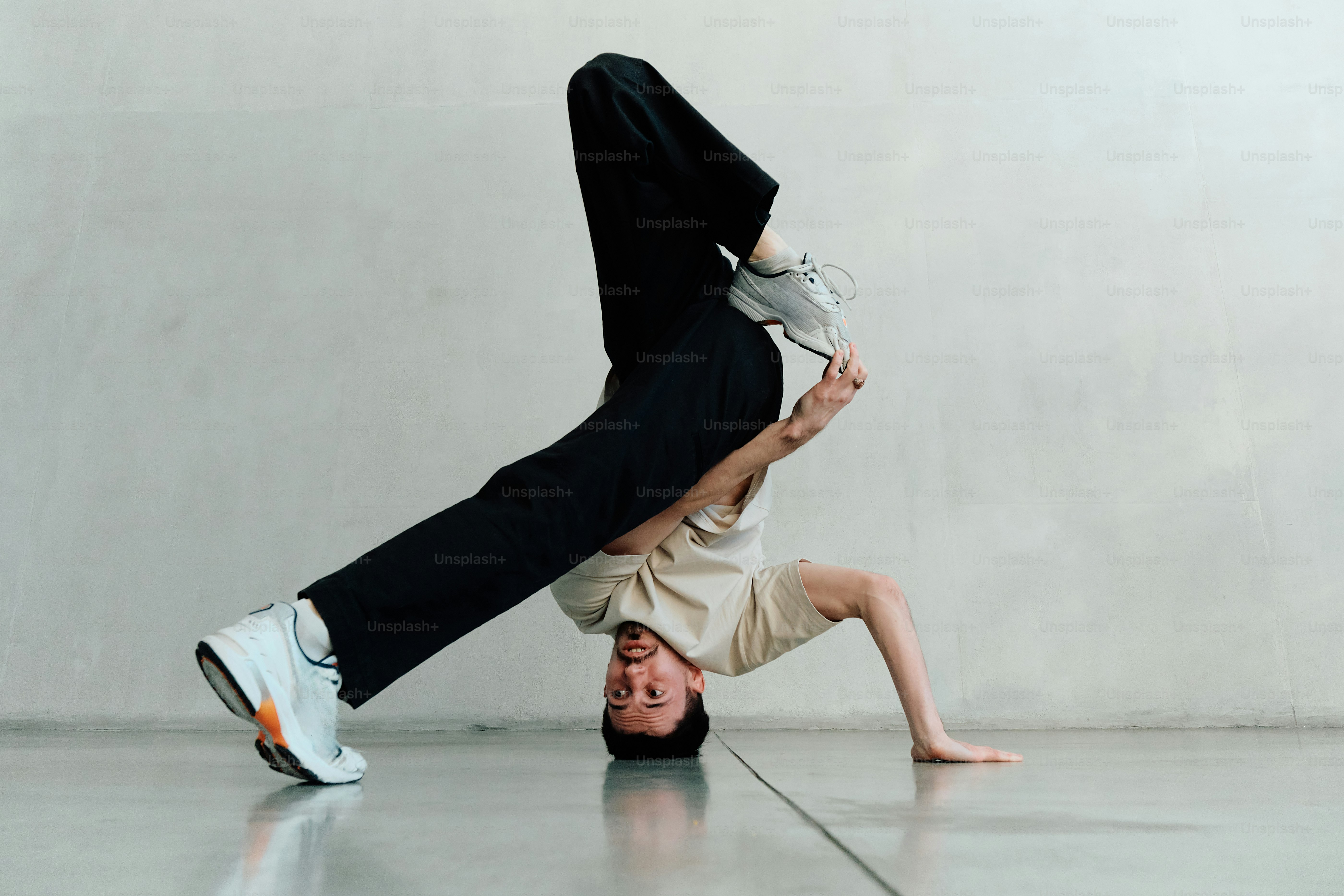 a man is doing a handstand on the floor