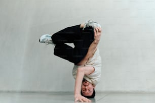 a man is doing a handstand on his head