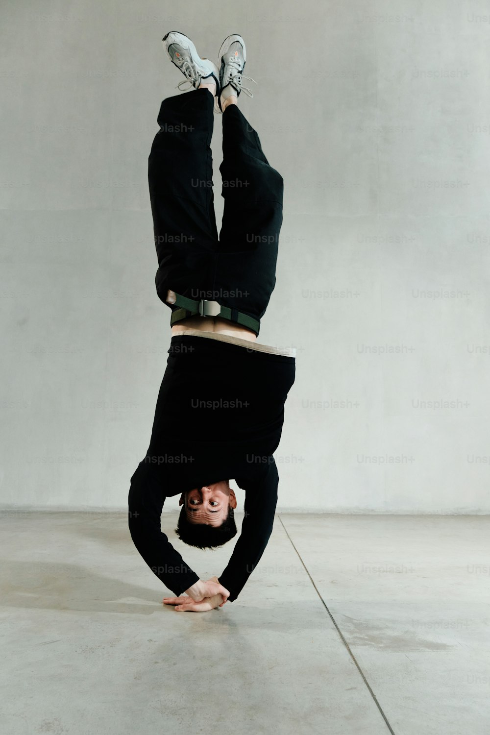 a man doing a handstand in a room
