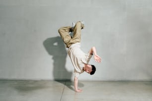 a man is doing a handstand on the floor
