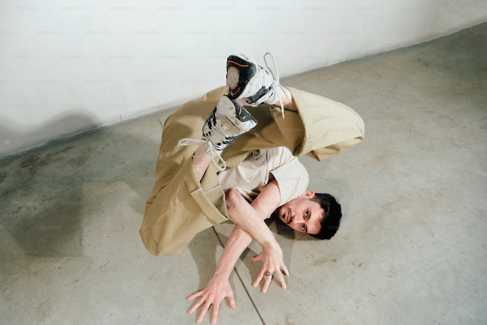 a man laying on the ground with a bag on his back