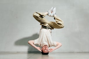 a man is doing a handstand on his head