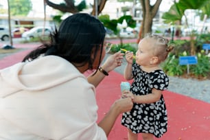a woman feeding a baby a piece of food