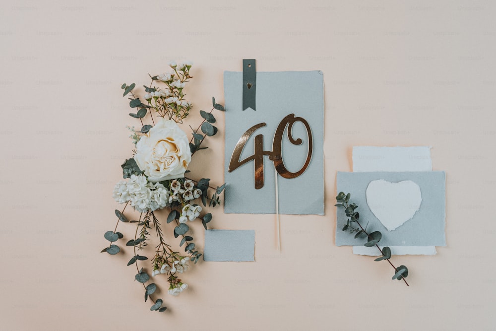 a bouquet of flowers next to a piece of paper with the number forty
