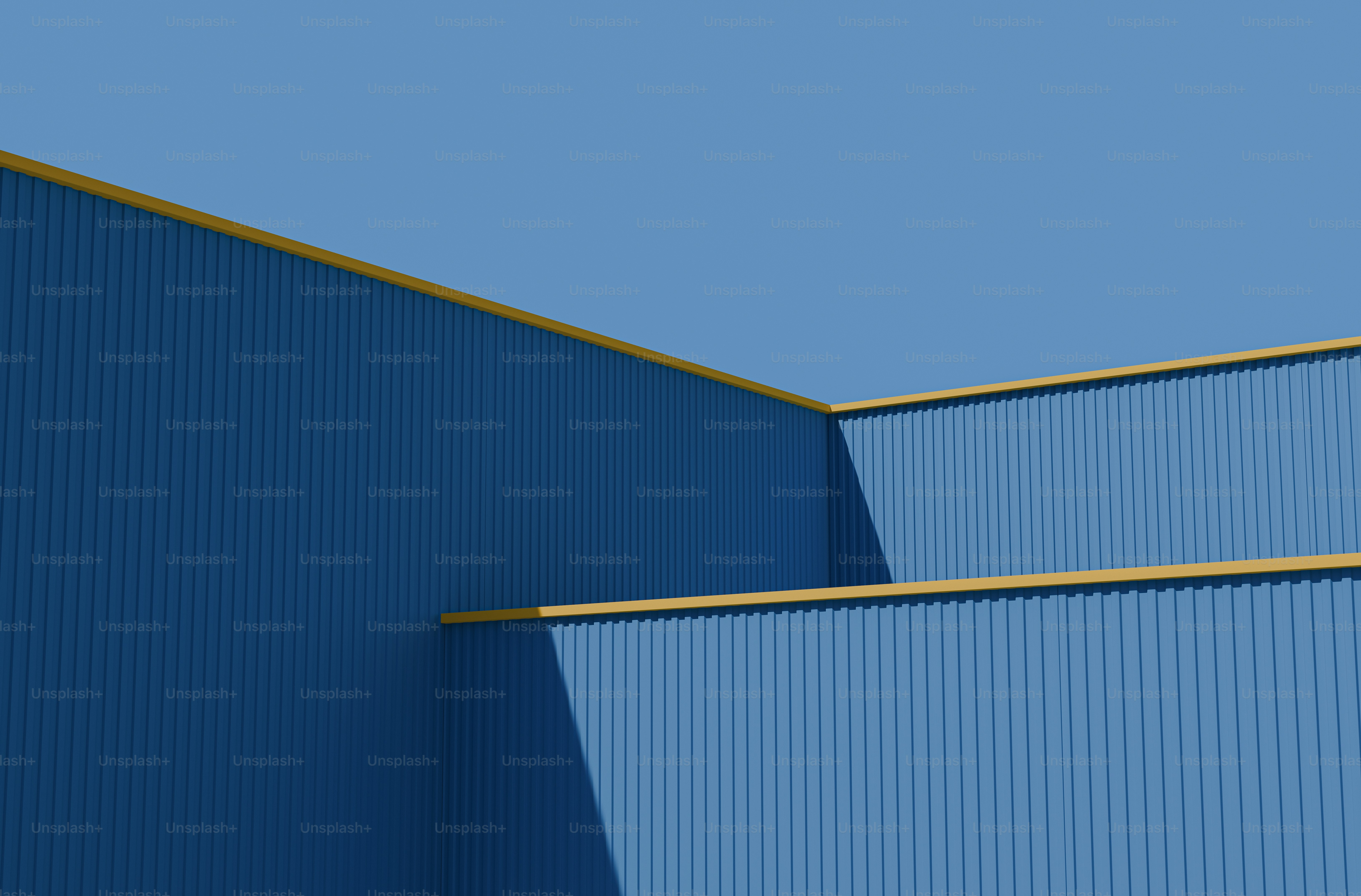 an airplane is flying over a blue building