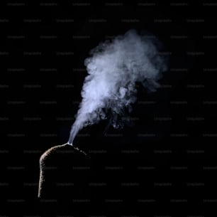 a person standing in the dark with smoke coming out of their head